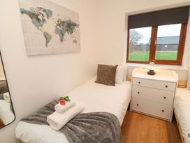 A bedroom with two beds and a map on the wall at Lodge 7 in South Hykeham