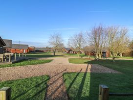 An outdoor area with lodges and trees at Lodge 7 South Hykeham