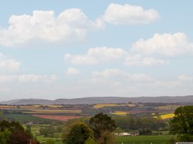 A landscape featuring fields, hills, and clouds at Palace Bungalow St Weonards