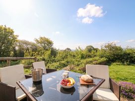 A table with fruit and drinks in the garden at Palace Bungalow St Weonards