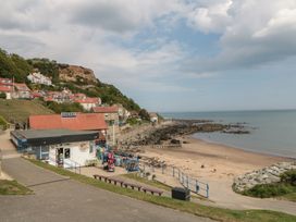 A beach with rocks and a shop at Primrose Lodge Runswick Bay near Staithes