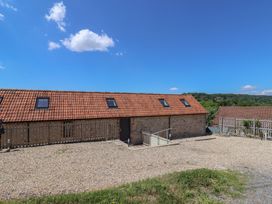 An outdoor view of a building with a gravel area at The Stables in Uplyme