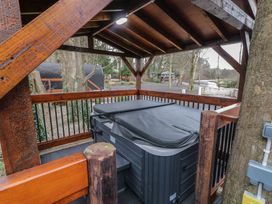 An outdoor covered wooden structure with a hot tub inside at Pine in Dungiven Londonderry