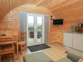 A living area with a table and chairs at Holly in Ulverston