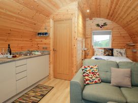 A living room with a kitchen and bed at Holly in Ulverston