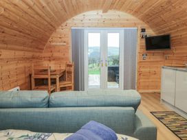 An interior view of a pod with a sofa and dining area at Holly in Ulverston