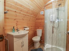 A bathroom with a shower, toilet, and sink at Holly in Ulverston