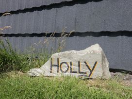 A rock with 'HOLLY' painted on it in an outdoor area at Holly in Ulverston