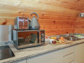 A kitchen with a microwave, kettle, and toaster at Willow in Ulverston