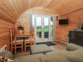 A living room with a table and chairs at Oak in Ulverston