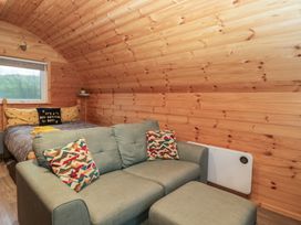 A bedroom with a bed and sofa at Oak in Ulverston