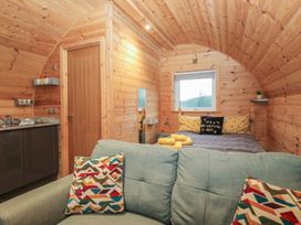 A bedroom with a bed and kitchenette at Oak in Ulverston