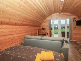 A living room with a sofa and dining area at Oak in Ulverston