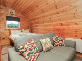 A bedroom with a bed and a sofa at Rowan in Ulverston