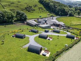 A glamping site with multiple pods and a barn at Rowan in Ulverston