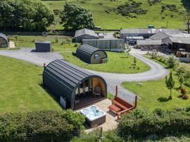 An outdoor area with a hot tub and structures at Rowan in Ulverston
