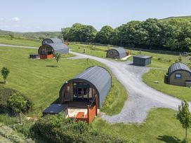 A group of cabins in a grassy area at Rowan Ulverston