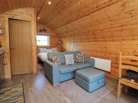 A living room with a sofa and bed at Cherry in Ulverston