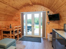 A living room with a table and chairs at Cherry in Ulverston