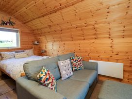 A bedroom with a bed and a sofa at Cherry in Ulverston