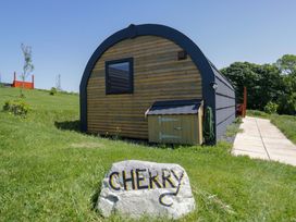 A cabin with a pathway and sign at Cherry in Ulverston