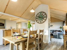 A dining room with a table and chairs at Lodge 14 in Corfe Castle