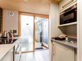A kitchen with a countertop, kettle, and microwave at Lodge 14 in Corfe Castle