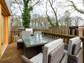 An outdoor area with a table and chairs at Lodge 14 Corfe Castle