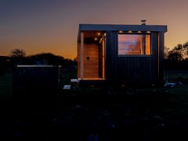 A tiny house with wooden exterior and window at Lodge 14 Corfe Castle