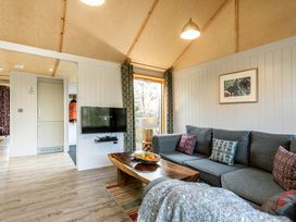 A living room with a sofa and coffee table at Lodge 16 in Corfe Castle