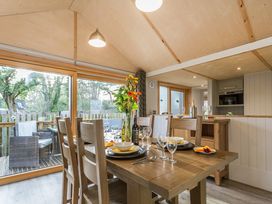 A dining room with a table set for meals at Lodge 17 in Corfe Castle