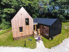 A house with wooden exterior and garden at Lodge 19 in Corfe Castle