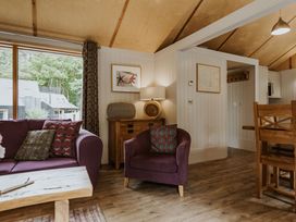 A living room with a sofa and armchair at Lodge 19 in Corfe Castle
