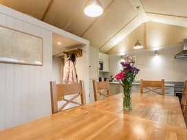 A kitchen with a dining table and flower vase at Lodge 19 in Corfe Castle