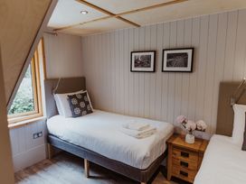A bedroom with two beds and a bedside table at Lodge 19 in Corfe Castle