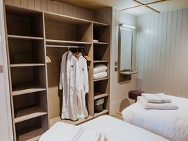 A bedroom with wardrobes and towels at Lodge 19 Corfe Castle