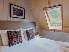 A bedroom with a bed and skylight at Lodge 19 in Corfe Castle