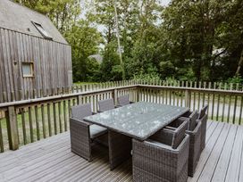 A patio with a table and chairs at Lodge 19 in Corfe Castle