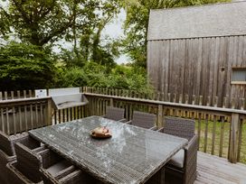 An outdoor dining area with a table and chairs at Lodge 19 in Corfe Castle