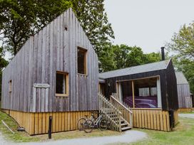 A wooden cabin with a staircase and bicycles at Lodge 19 in Corfe Castle