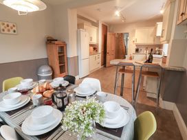 A kitchen with a dining table set and kitchen appliances at Elkhorn in Southwold