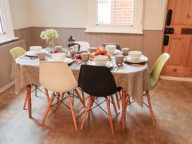 A dining room with a table set for a meal at Elkhorn in Southwold
