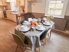 A dining room with a table set for breakfast at Elkhorn in Southwold
