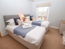 A bedroom with two beds and a window at Elkhorn in Southwold