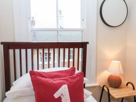 A bedroom with a bed and lamp at Elkhorn in Southwold