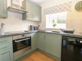 A kitchen with countertop oven and sink at 14 The Dell Mundesley