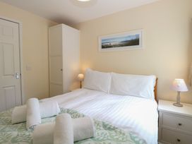 A bedroom with a bed and wardrobe at 14 The Dell Mundesley