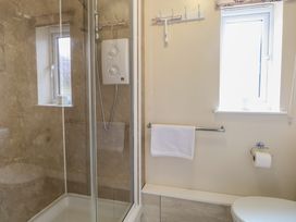A bathroom with a shower and toilet at 14 The Dell Mundesley