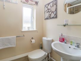 A bathroom with a toilet and sink at 14 The Dell Mundesley