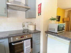 A kitchen with oven, stove, and microwave at 15 The Dell Mundesley